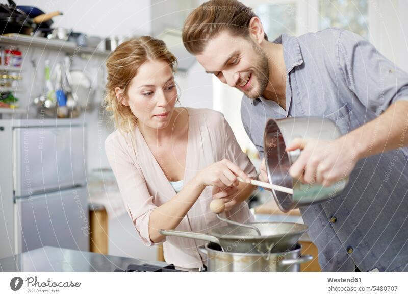 Couple cooking in kitchen together caucasian caucasian ethnicity caucasian appearance european Cooker Cookers preparing Food Preparation preparing food