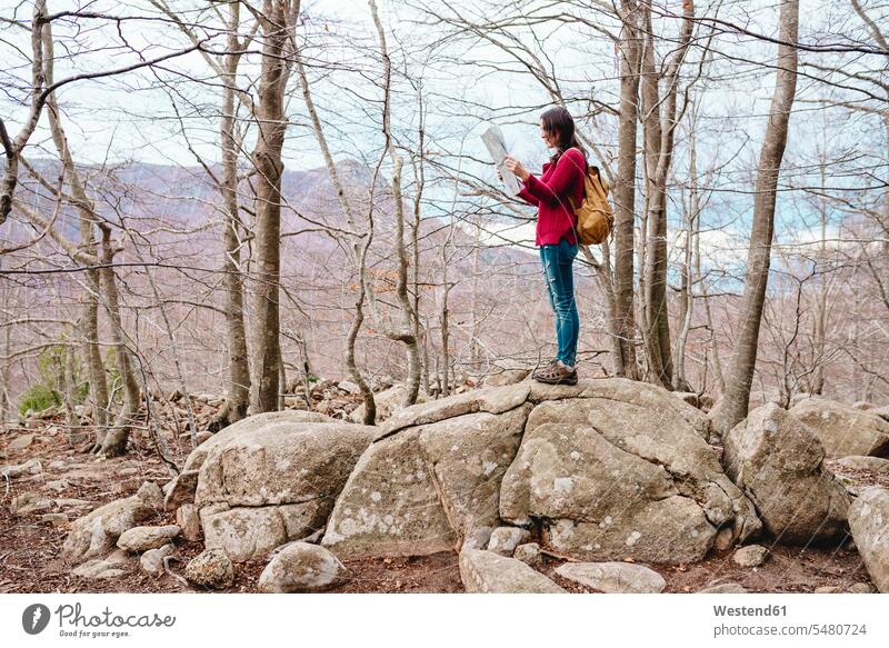 Spain, Barcelona Province, Sants Fe del Montseny, woman with backpack and map in the mountains caucasian caucasian ethnicity caucasian appearance european
