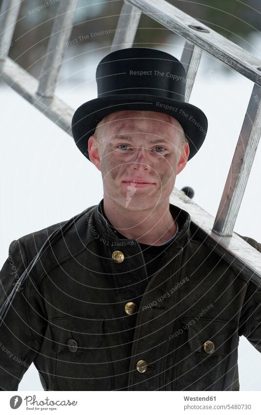 Germany, portrait of chimney sweep with ladder wearing top hat chimney sweepers portraits ladders caucasian caucasian ethnicity caucasian appearance european
