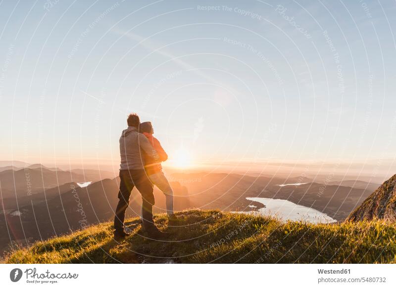 Austria, Salzkammergut, Couple standing on mountain summit, enjoying the view caucasian caucasian appearance caucasian ethnicity european White - Caucasian