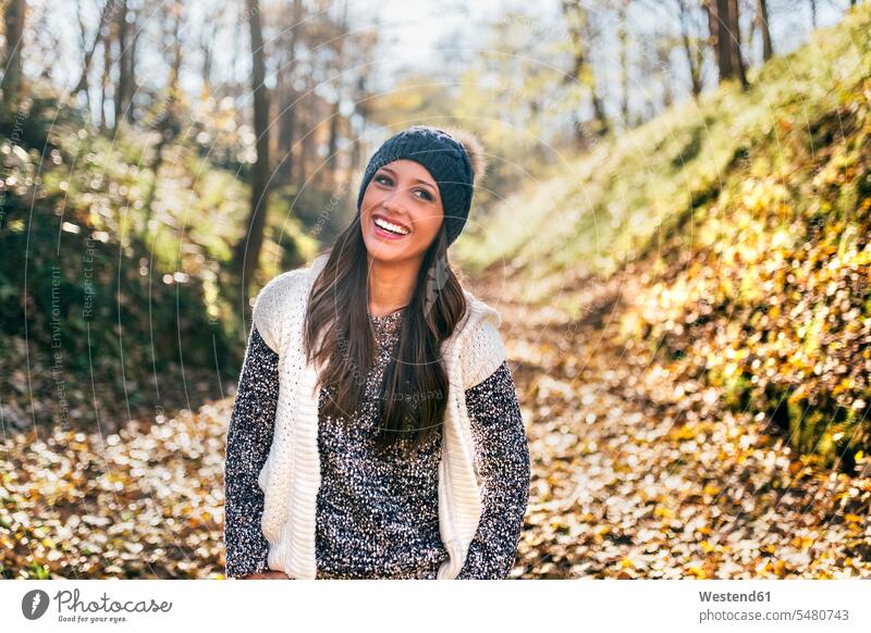 Portrait of a beautiful happy woman in an autumnal forest woods forests fall happiness females women portrait portraits Adults grown-ups grownups adult people