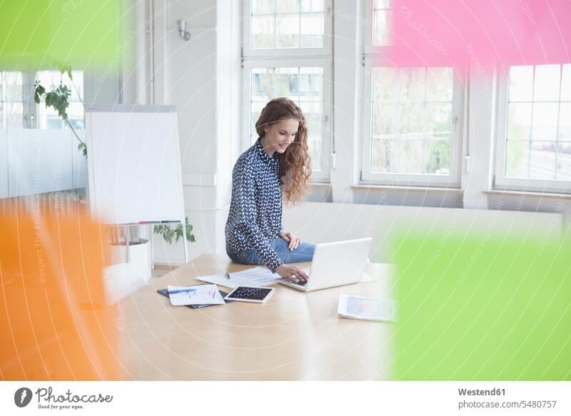 Woman using laptop in boardroom office offices office room office rooms Laptop Computers laptops notebook woman females women workplace work place place of work