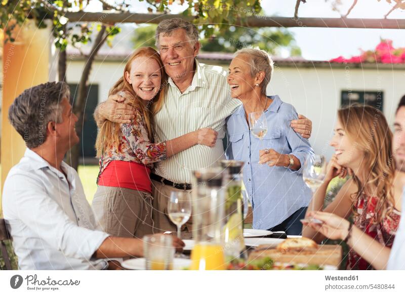 Happy senior couple with family having lunch together outside families happiness happy Fun having fun funny celebrating celebrate partying Garden Party