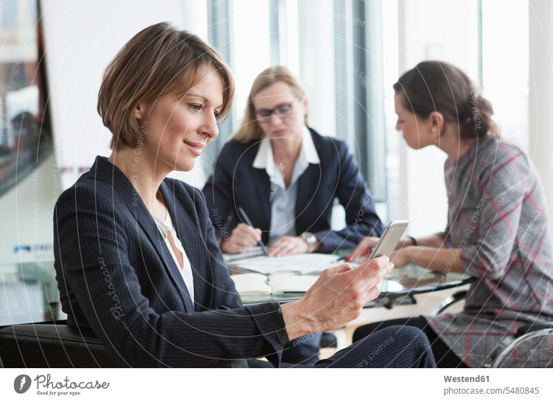 Businesswoman using cell phone in a meeting caucasian caucasian ethnicity caucasian appearance european technology technologies Technological day daylight shot