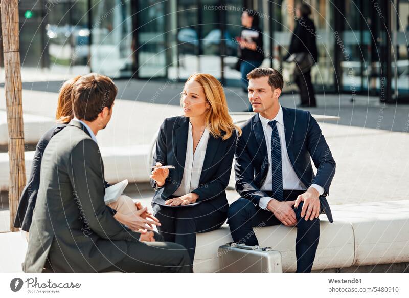 Business colleagues talking outside office building Meeting Meetings Business Meeting speaking conversations business conference meeting discussion