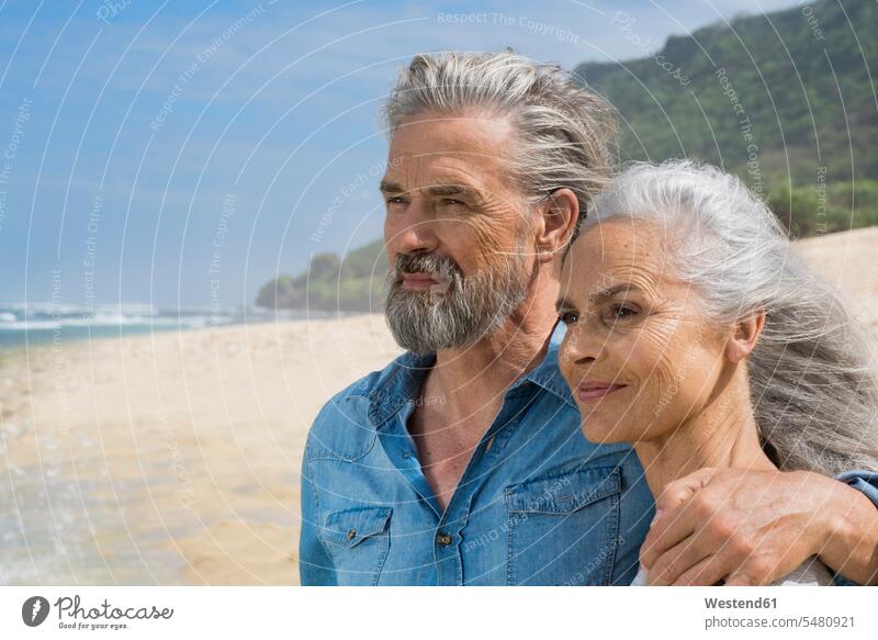 Portrait of a handsome senior couple at the sea embracing embrace Embracement hug hugging senior adults seniors old beach beaches vacation Holidays attractive