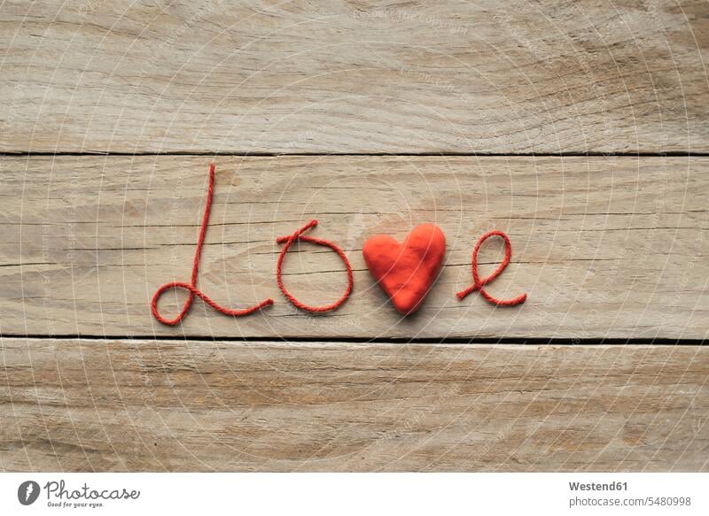 The word 'Love' formed of red threads and a heart Idea Ideas heart-shape love heart loveheart hearts heart shaped close-up close up closeups close ups close-ups