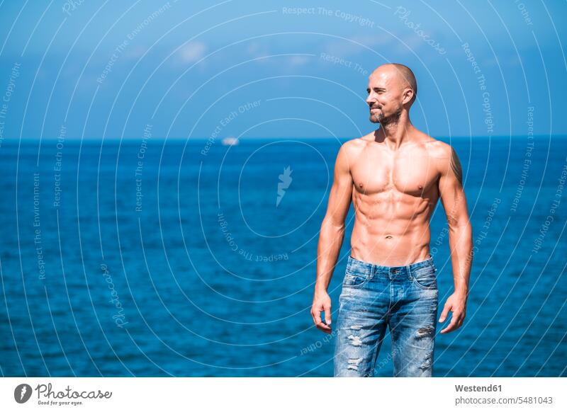 Muscular man standing in front of the sea caucasian caucasian ethnicity caucasian appearance european copy space Spain day daylight shot daylight shots