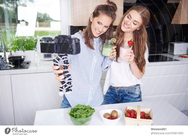 Food bloggers filming theirselves drinking smoothies cameras smile domestic kitchen kitchens Alimentation food Food and Drinks Nutrition Beverage beverages