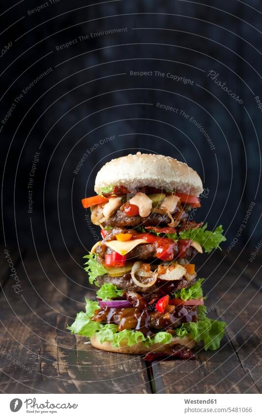 Extra large hamburger nobody bacon Bacons speck Tomato Tomatoes Cheese massive fatty lettuce leaf lettuce leaves copy space Gherkin Pickled Gherkins onion ring