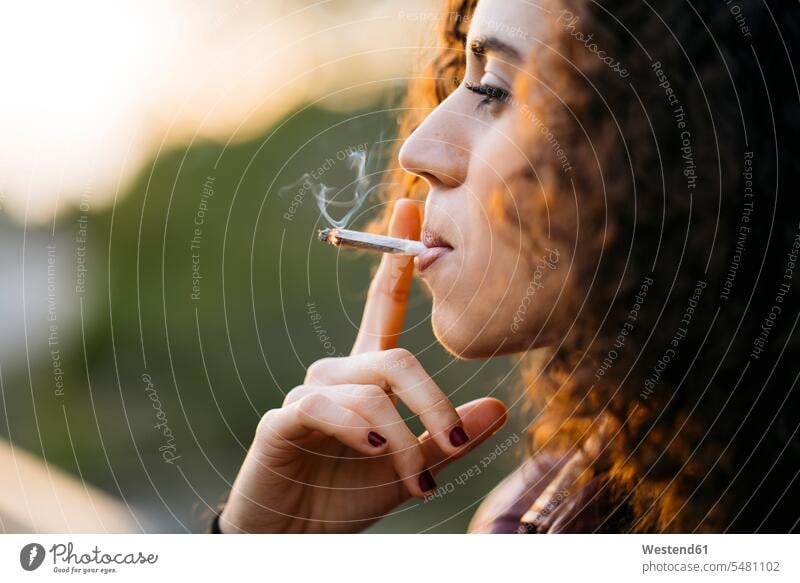 Smoking young woman cigarette cigarettes females women smoking smoke tobacco product Tobacco Products Adults grown-ups grownups adult people persons human being