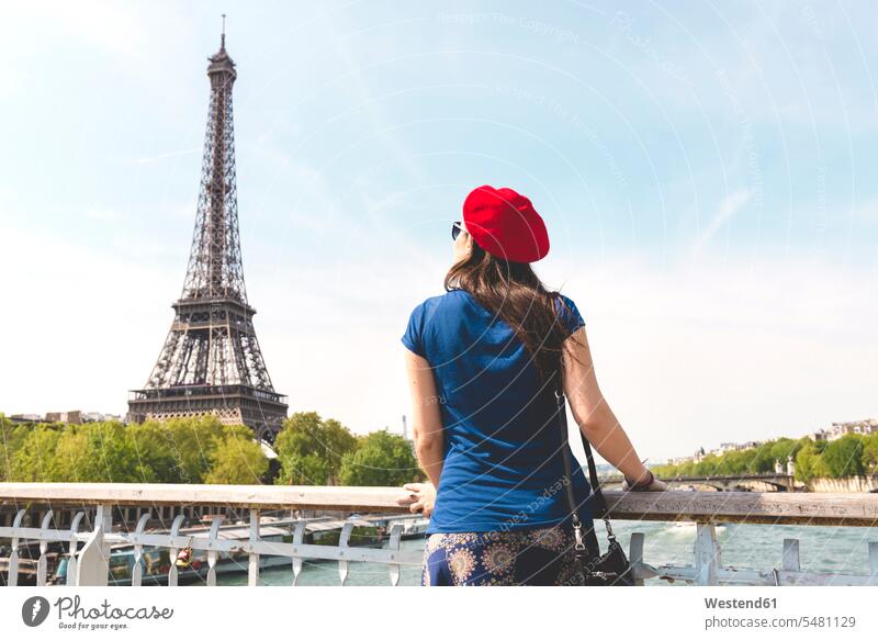France, Paris, back view of woman wearing red beret looking at Eiffel Tower females women Ile-de-France tower towers built structure buildings built structures
