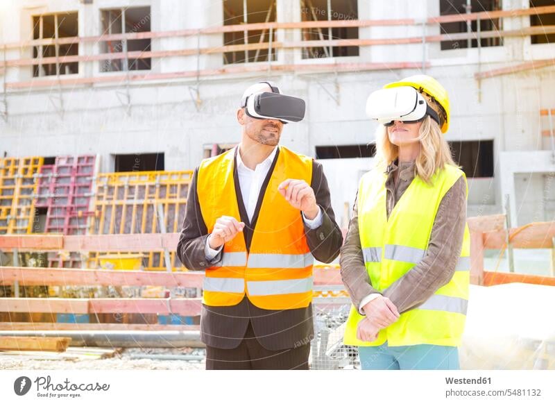 Two persons with Virtual Reality Glasses at construction site three-quarter length three quarter length Germany virtual senses wearable wearable computers