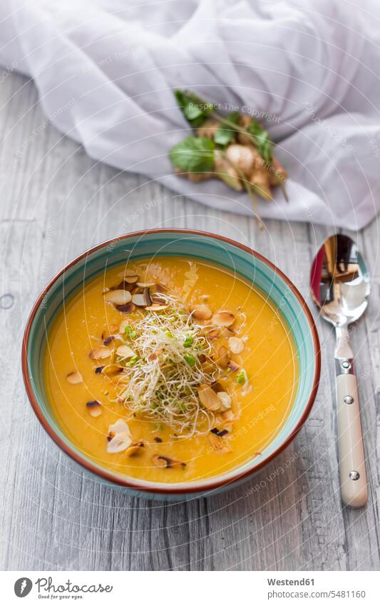 Bowl of sweet potato coconut soup with ginger, parsnip, leek, sprout and almond food and drink Nutrition Alimentation Food and Drinks creme of vegetable soup