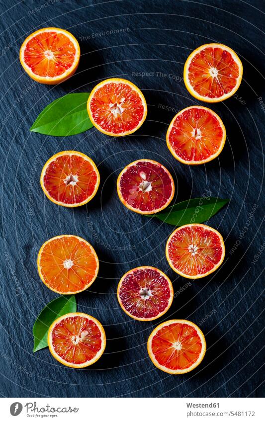 Sliced blood oranges on slate food and drink Nutrition Alimentation Food and Drinks vitamines Orange Citrus sinensis Oranges variation Leaf Leaves