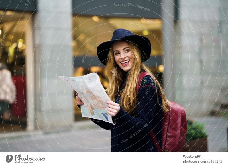 Portrait of happy tourist with city map and backpack portrait portraits city maps female tourist tourists tourism touristic Exploration exploring explore woman