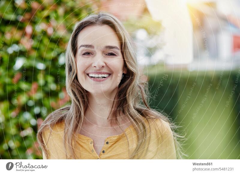 Portrait of happy woman in garden smiling smile females women portrait portraits happiness Adults grown-ups grownups adult people persons human being humans