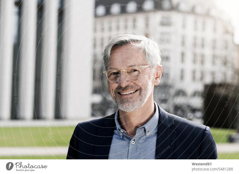 Grey-haired businessman smiling into camera portrait portraits smile Businessman Business man Businessmen Business men business people businesspeople