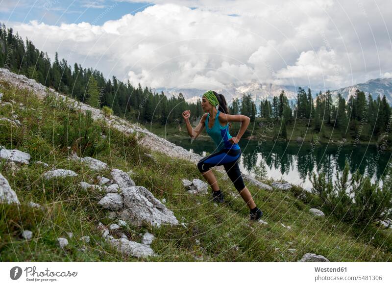 Italy, Dolomites, Veneto, trail runner at Federa Lake woman females women athlete sportswoman athletes female athlete sportswomen female athletes running