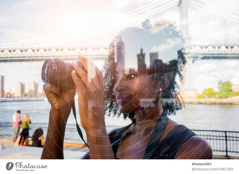 USA, New York City, Brooklyn, woman looking at camera photographing females women cameras Adults grown-ups grownups adult people persons human being humans