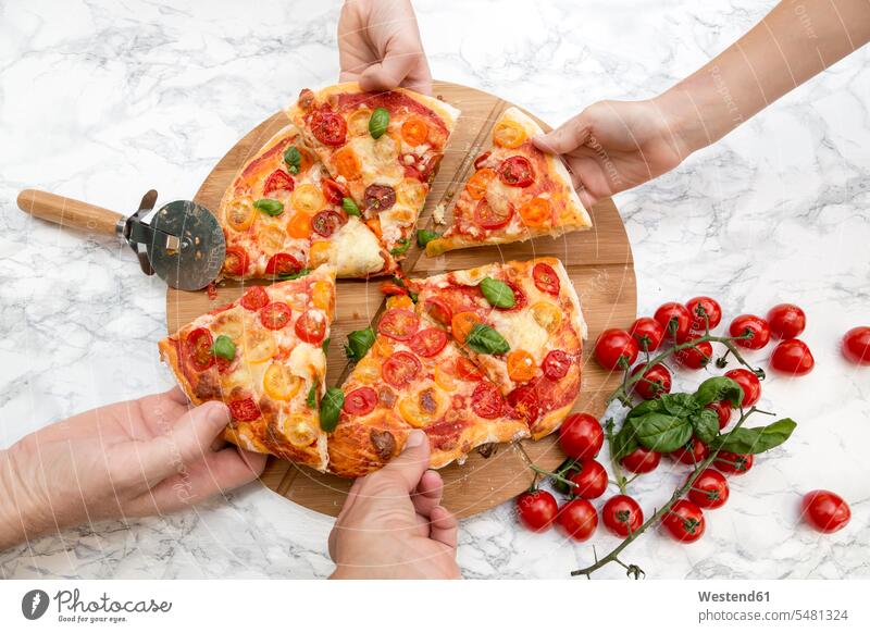 Vegetarian pizza with mozzarella and tomatoes, hands taking peace of pizza caucasian caucasian ethnicity caucasian appearance european Mozzarella homemade