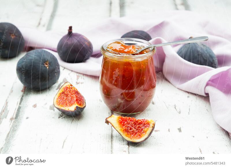 Organic figs and a glass of fig jam on a wood uncooked healthy eating nutrition wooden raw homemade home made home-made organic organic edibles preserved