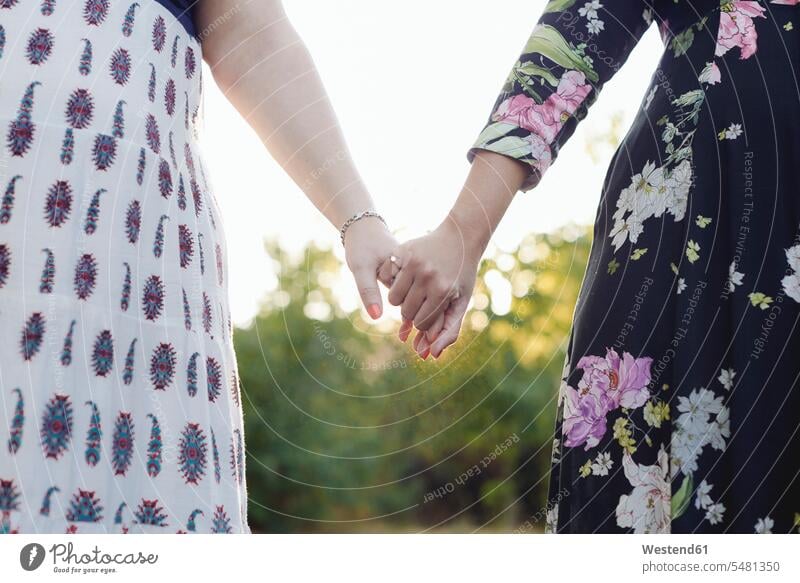 Two best friends holding hands, partial view female friends human hand human hands mate friendship people persons human being humans human beings fashionable