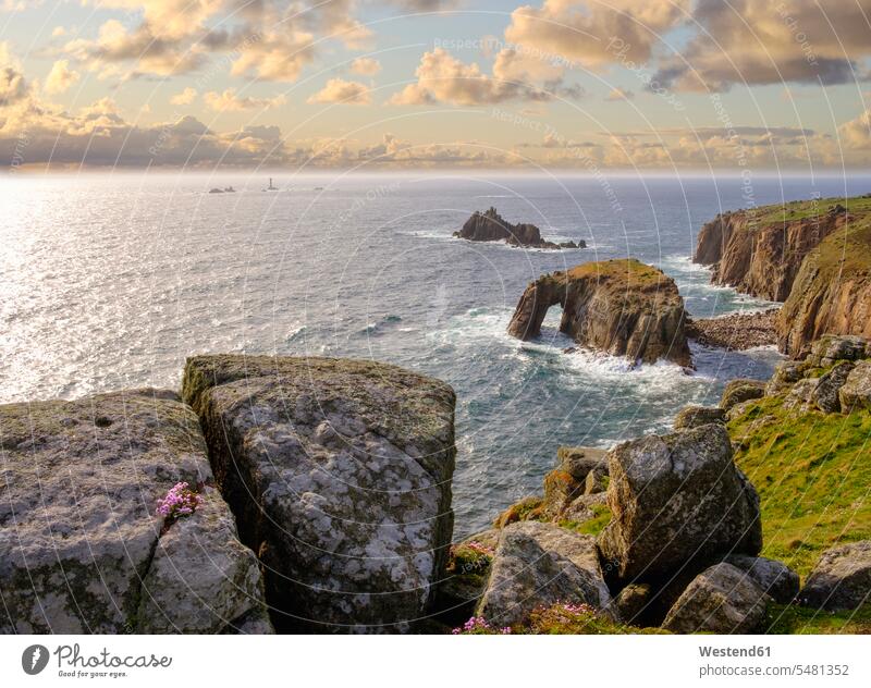 UK, England, Cornwall, Land's End, cliff coast with Enys Dodman Rock and Longships Lighthouse in background rock formation Rock Formations day daylight shot