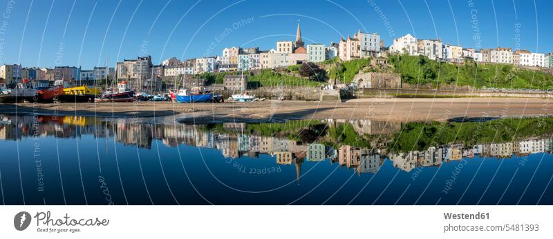 UK, Wales, Pembrokeshire, Tenby, panoramic view of harbour, low tide, water reflection boat boats sea ocean clear sky copy space cloudless Travel destination