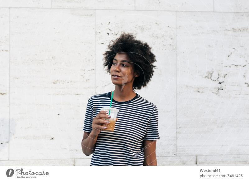 Portrait of woman with drink watching something Drink beverages Drinks Beverage portrait portraits females women food and drink Nutrition Alimentation