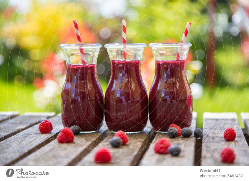 Row of three raspberry blueberry smoothies food and drink Nutrition Alimentation Food and Drinks outdoors outdoor shots location shot location shots Raspberry