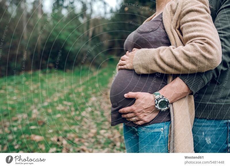 Man with pregnant woman in nature Pregnant Woman couple twosomes partnership couples people persons human being humans human beings standing leisure free time