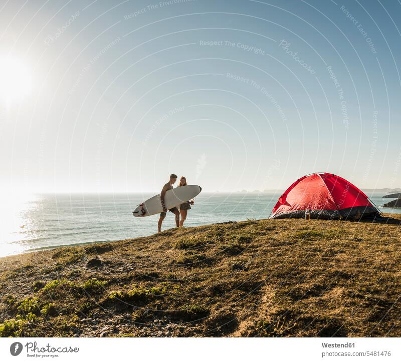 Young couple with surfboard camping at seaside twosomes partnership couples people persons human being humans human beings surfboards Sea ocean surfing