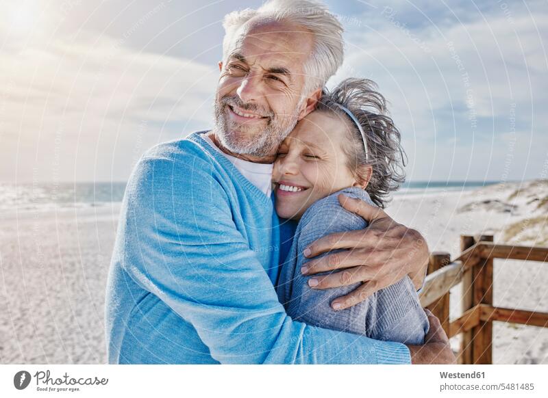 Portrait of couple on the beach beaches twosomes partnership couples embracing embrace Embracement hug hugging people persons human being humans human beings