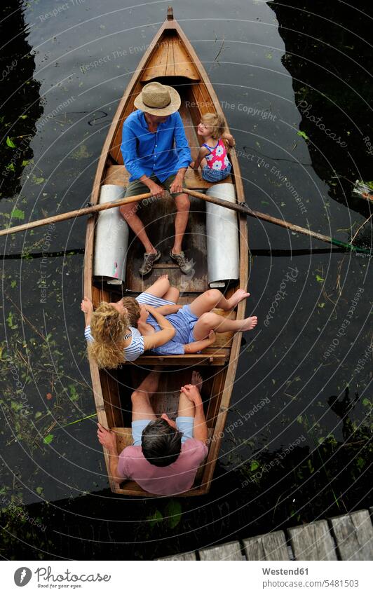 Family in rowing boat, top view family families rowboat rowing boats rowboats people persons human being humans human beings vessel water vehicle on the move