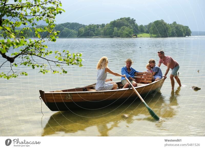 Germany, Bavaria, Murnau, family in rowing boat at lakeshore rowboat rowing boats rowboats Lakeshore Lake Shore lakeside families vessel water vehicle