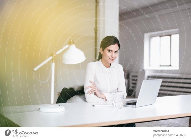 Portrait of businesswoman using laptop at table businesswomen business woman business women Laptop Computers laptops notebook females business people