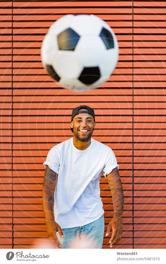 Portrait of laughing man having fun with soccer ball portrait portraits men males soccer balls footballs Adults grown-ups grownups adult people persons
