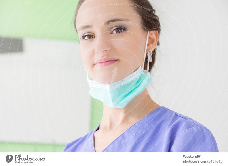 Portrait of smiling female dentist with mask portrait portraits smile woman females women female dentists female dental surgeons Adults grown-ups grownups adult