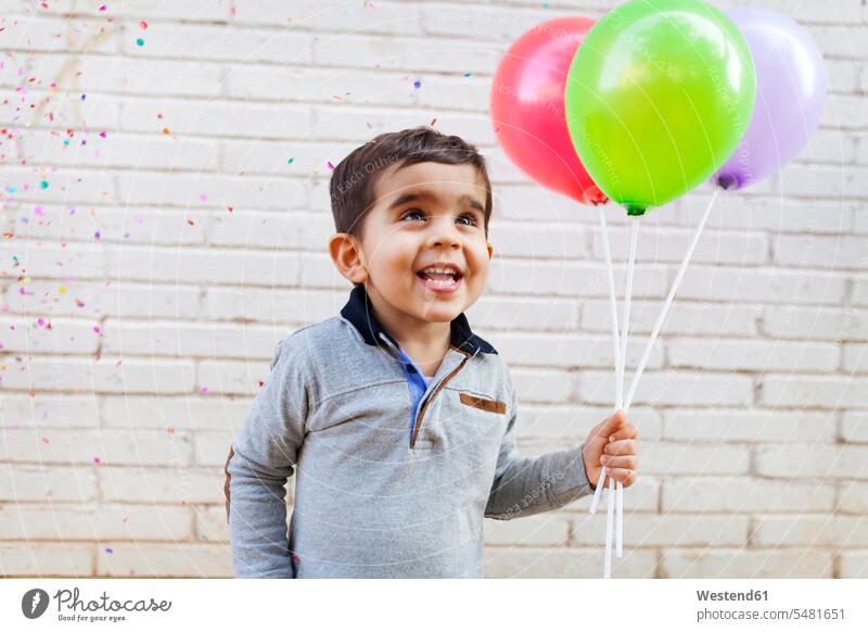 Portrait of happy toddler holding three balloons caucasian caucasian ethnicity caucasian appearance european one person 1 one person only only one person
