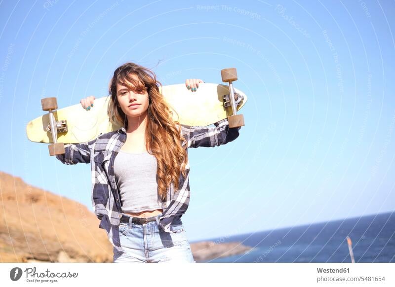 Spain, portrait of teenage girl with longboard on shoulders caucasian caucasian ethnicity caucasian appearance european youth skateboard Skate Board skateboards