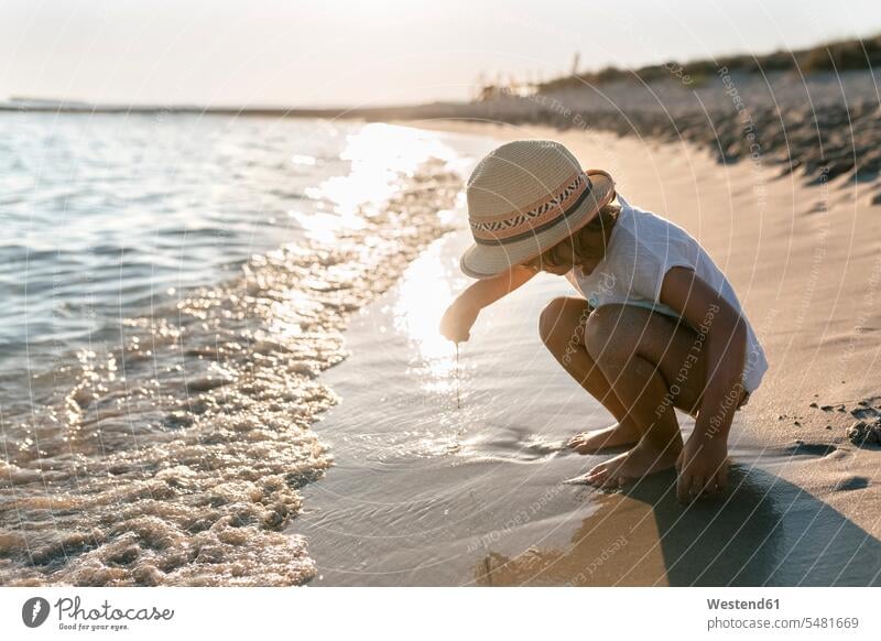 Spain, Menorca, little girl playing on the beach females girls beaches child children kid kids people persons human being humans human beings vacation Holidays
