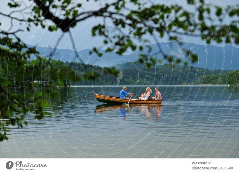 Germany, Bavaria, Murnau, family in rowing boat rowboat rowing boats rowboats families vessel water vehicle people persons human being humans human beings