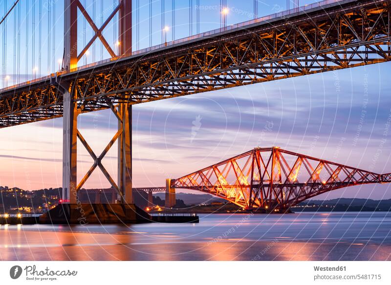 UK, Scotland, Fife, Edinburgh, Firth of Forth estuary, Forth Bridge and Forth Road Bridge at sunset illuminated lit lighted Illuminating nature natural world