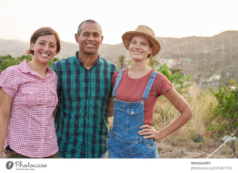 Group picture of three happy farmers friends portrait portraits friendship agriculturists agriculture Gran Canaria Grand Canary arm in arm toothy smile