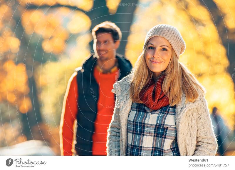 Happy couple enjoying autumn in a park caucasian caucasian ethnicity caucasian appearance european smiling smile relaxation relaxing Joy enjoyment pleasure