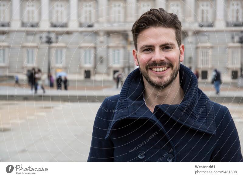 Portrait of smiling man wearing a coat outdoors men males portrait portraits smile Adults grown-ups grownups adult people persons human being humans