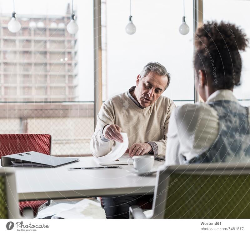 Businessman and young woman in conference room office offices office room office rooms Business man Businessmen Business men Business Meeting