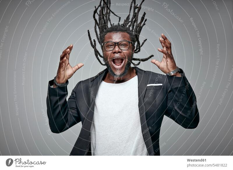 Portrait of screaming man tossing his dreadlocks shouting men males portrait portraits Adults grown-ups grownups adult people persons human being humans