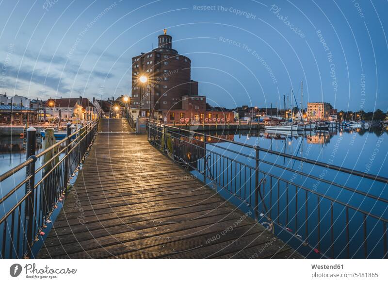 Germany, Eckernfoerde, view to old silo and harbour at evening twilight illuminated lit lighted Illuminating Architecture pier shipping pier light beam